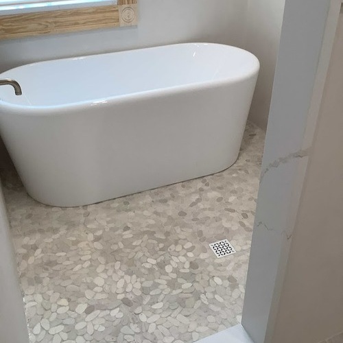 white bathtub being installed