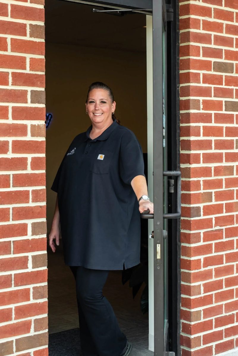 Crystal Owens of Serenity Plumbing at the office door
