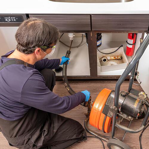 plumber providing drain cleaning