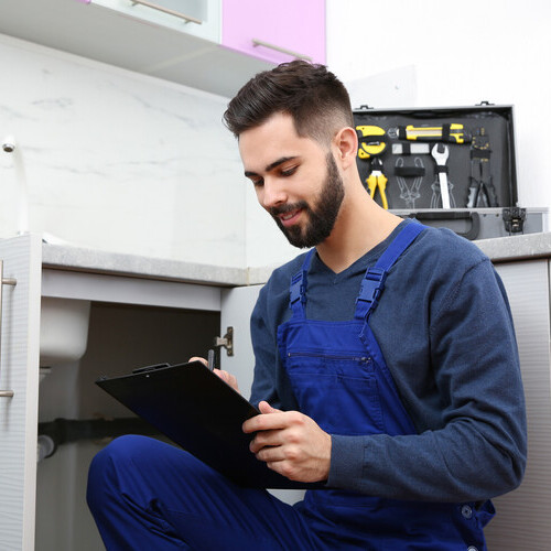 plumber working on a sink