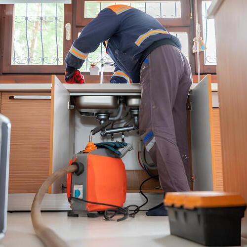 plumber working on a drain